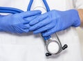 Close up of doctor hands in gloves with stethoscope, medical exam concept