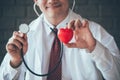 Close up of doctor hands holding red heart and stethoscope Royalty Free Stock Photo