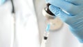 Close-up of doctor hands in protective gloves filling the syringe with medicine. Royalty Free Stock Photo
