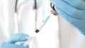 Close-up of doctor hands in protective gloves filling the syringe with medicine. Royalty Free Stock Photo