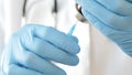 Close-up of doctor hands in protective gloves filling the syringe with medicine. Royalty Free Stock Photo