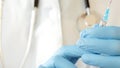 Close-up of doctor hands in protective gloves filling the syringe with medicine. Royalty Free Stock Photo