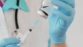 Close-up of doctor hands in protective gloves filling the syringe with medicine. Royalty Free Stock Photo