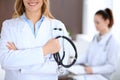 Close up of a doctor holding a stethoscope in his hand while standing in medical office Royalty Free Stock Photo