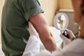 Close up of doctor inspecting skin with magnifying glass