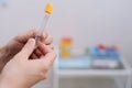 Close-up of doctor in the laboratory with a blood tube for analysis.