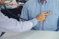 Close up of doctor listening to patient heartbeat with stethoscope on hospital, Physical examination, Medical and health care con Royalty Free Stock Photo