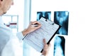 doctor is making entries in the patient& x27;s registration form. Royalty Free Stock Photo