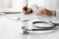 Close-up of doctor medical professional wearing uniform taking notes, physician or therapist  filling medical document Royalty Free Stock Photo