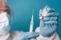 Close up of doctor or nurse holding viol with vaccine against corona virus, taking covid vaccination booster shot or 3rd Royalty Free Stock Photo