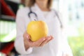 Doctor nutritionist holding ripe yellow apple in hand Royalty Free Stock Photo