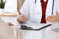 Close up of a doctor and patient hands while discussing medical records after health examination Royalty Free Stock Photo