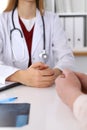 Close up of a doctor and patient hands while discussing medical records after health examination Royalty Free Stock Photo