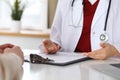 Close up of a doctor and patient hands while discussing medical records after health examination