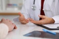 Close up of a doctor and patient hands while discussing medical records after health examination Royalty Free Stock Photo