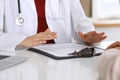 Close up of a doctor and patient hands while discussing medical records after health examination Royalty Free Stock Photo