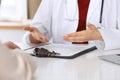 Close up of a doctor and patient hands while discussing medical records after health examination Royalty Free Stock Photo