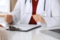 Close up of a doctor and patient hands while discussing medical records after health examination Royalty Free Stock Photo