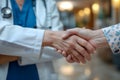 Doctor and patient handshake in hospital, healthcare trust concept