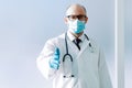 doctor in a protective mask holding out his hand for a handshake . Royalty Free Stock Photo