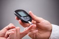 Doctor Checking Patient`s Sugar Level With Glucometer