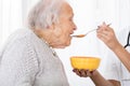 Doctor Hand Feeding Soup To Patient