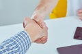 Close up of a male doctor shaking hands with his male patient. Medicine and trust concept