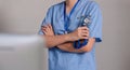 Close up a doctor standing with his arms crossed holding a stethoscope, a doctor from the hospital. Medical staff people Royalty Free Stock Photo