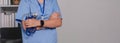 Close up a doctor standing with his arms crossed holding a stethoscope, a doctor from the hospital. Medical staff people Royalty Free Stock Photo