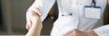 Doctor woman greet patient and shake hand, medical worker in uniform