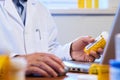 Doctor writing out prescription on a laptop Royalty Free Stock Photo