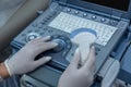 Close up of doctors hand on ultrasonography apparatus