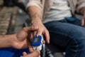 Close up of doctors hands measuring patients pulse with pulsometer