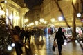 CLOSE UP: Tourists walk past market stalls in Zagreb on a cold winter evening.