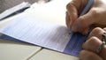 CLOSE UP Unknown businesswoman signs an important immigration form during flight Royalty Free Stock Photo