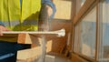 CLOSE UP, DOF: Unrecognizable builder cuts a plasterboard with a rusty jigsaw.