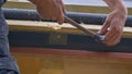 CLOSE UP Worker hammers nails while installing an insect mesh along wooden frame