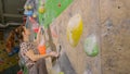 CLOSE UP: Young woman climbs challenging route while training at bouldering gym. Royalty Free Stock Photo