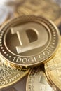 Close-up of dogecoin physical coin on stack of many other cryptocurrencies