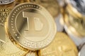 Close-up of dogecoin physical coin on stack of many other cryptocurrencies