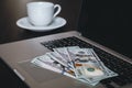 Close-up, dollar bills on a laptop, the concept of making money and working. Royalty Free Stock Photo