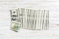 Close up of 100 dollar bills in a row on wooden background. Top view of salary concept Royalty Free Stock Photo