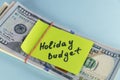 Close up dollars cash money in clip with text written note Holiday budget , concept of financial planning of set budget for Royalty Free Stock Photo