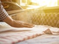 Close up domestic iron with steam go out houswork over the table ironing clothes against sunrays Royalty Free Stock Photo