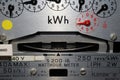 Close-up of a domestic kWh electric meter and slow turning measuring dial. Royalty Free Stock Photo