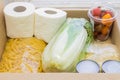 Close up of  donation box. Food supplies  for quarantine isolation period - pasta, vegetables, cans, toilet paper Royalty Free Stock Photo