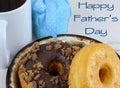 Close up of donuts, or doughnuts, on a brown ceramic plate. Good image for donuts and dads for father`s day in June.