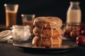 Close-up of donuts in stack with milk bottle and glass