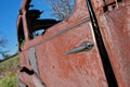 Close up of Door of Derelict and rusty antique Vintage Car in a Farm Field on a Sunny Day