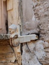 Close-up of a door knocker on the side of an aged structure